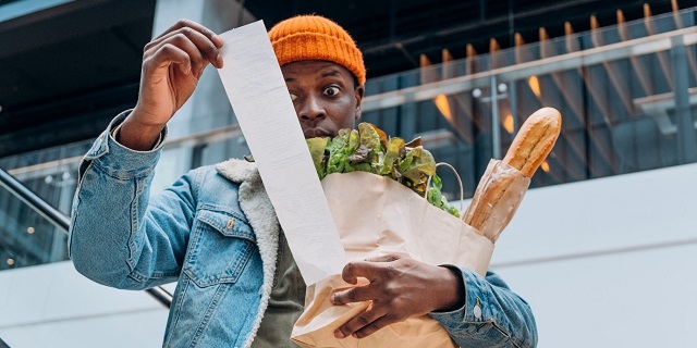 A Man Frustrated At A Grocery Bill